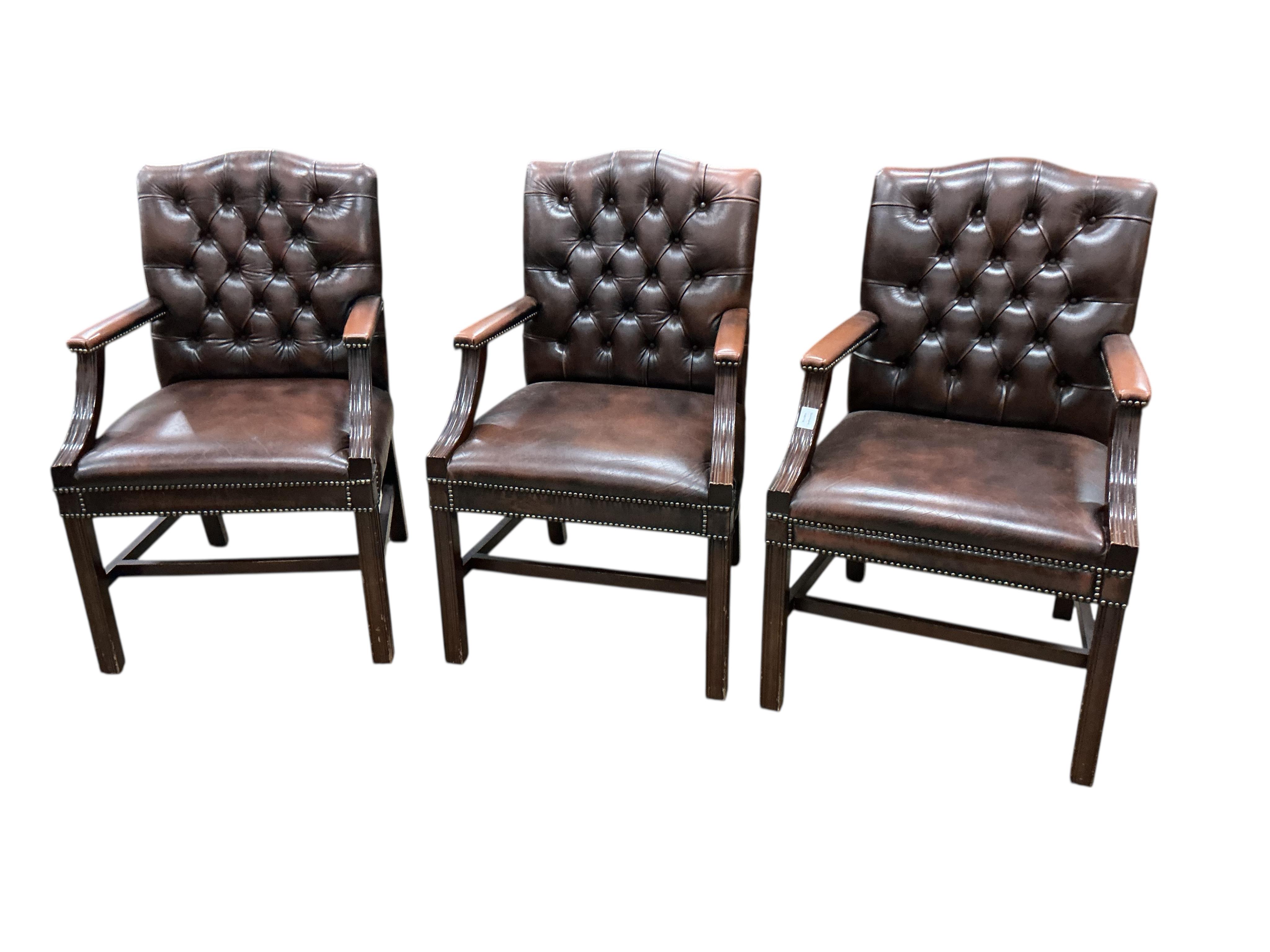 Three George III style button brown leather mahogany Gainsborough type chairs, width 62cm, depth 52cm, height 98cm